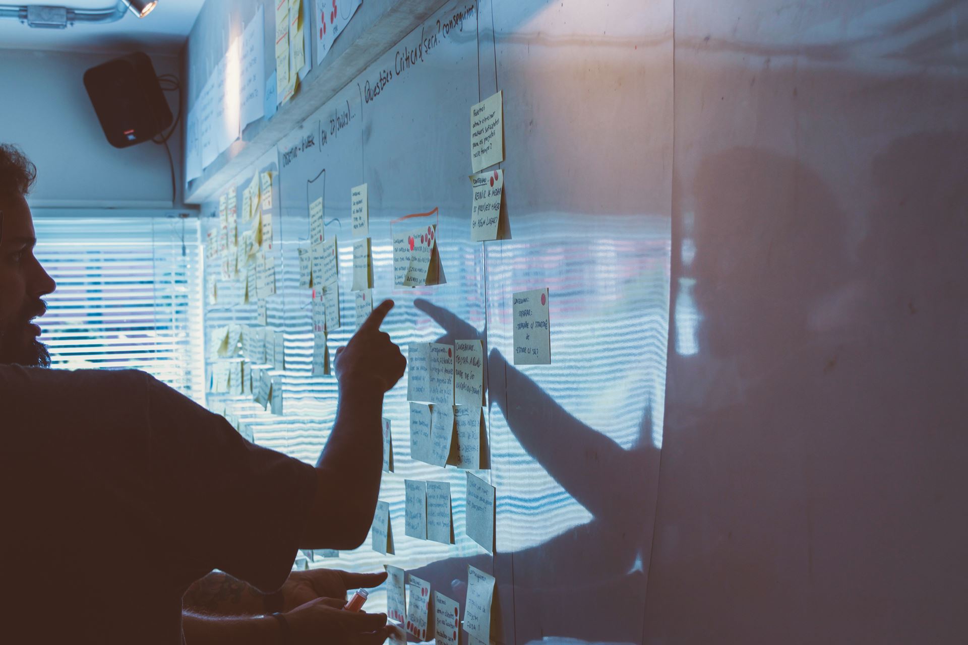 Person looking at a board of sticky notes