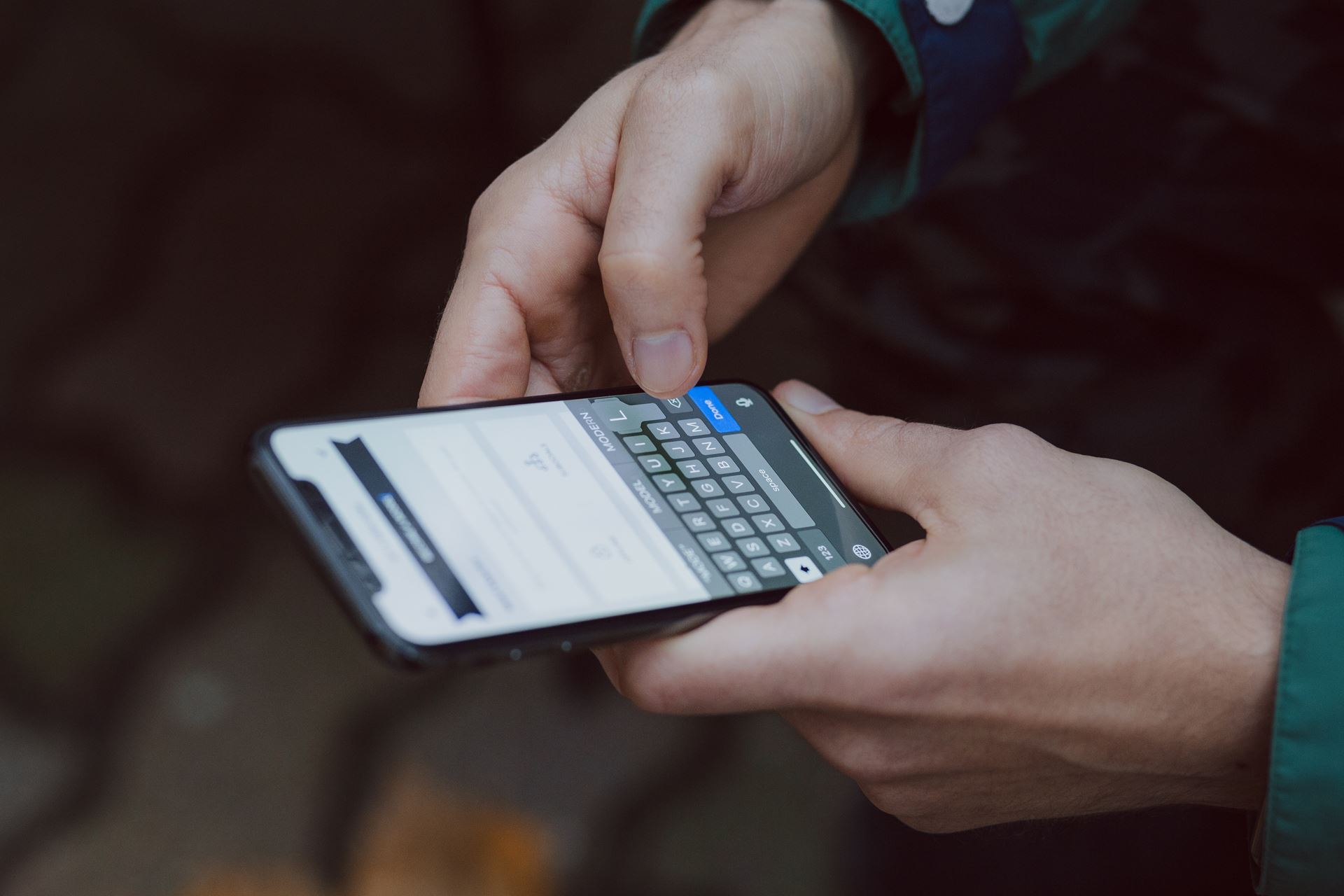 Hands using a mobile phone