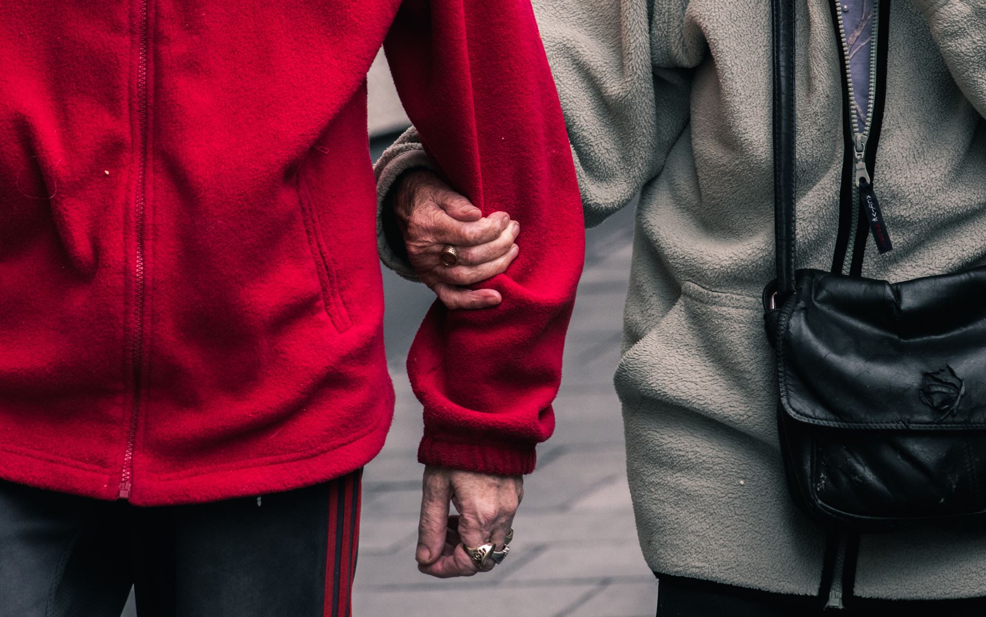 Two people walking arm in arm